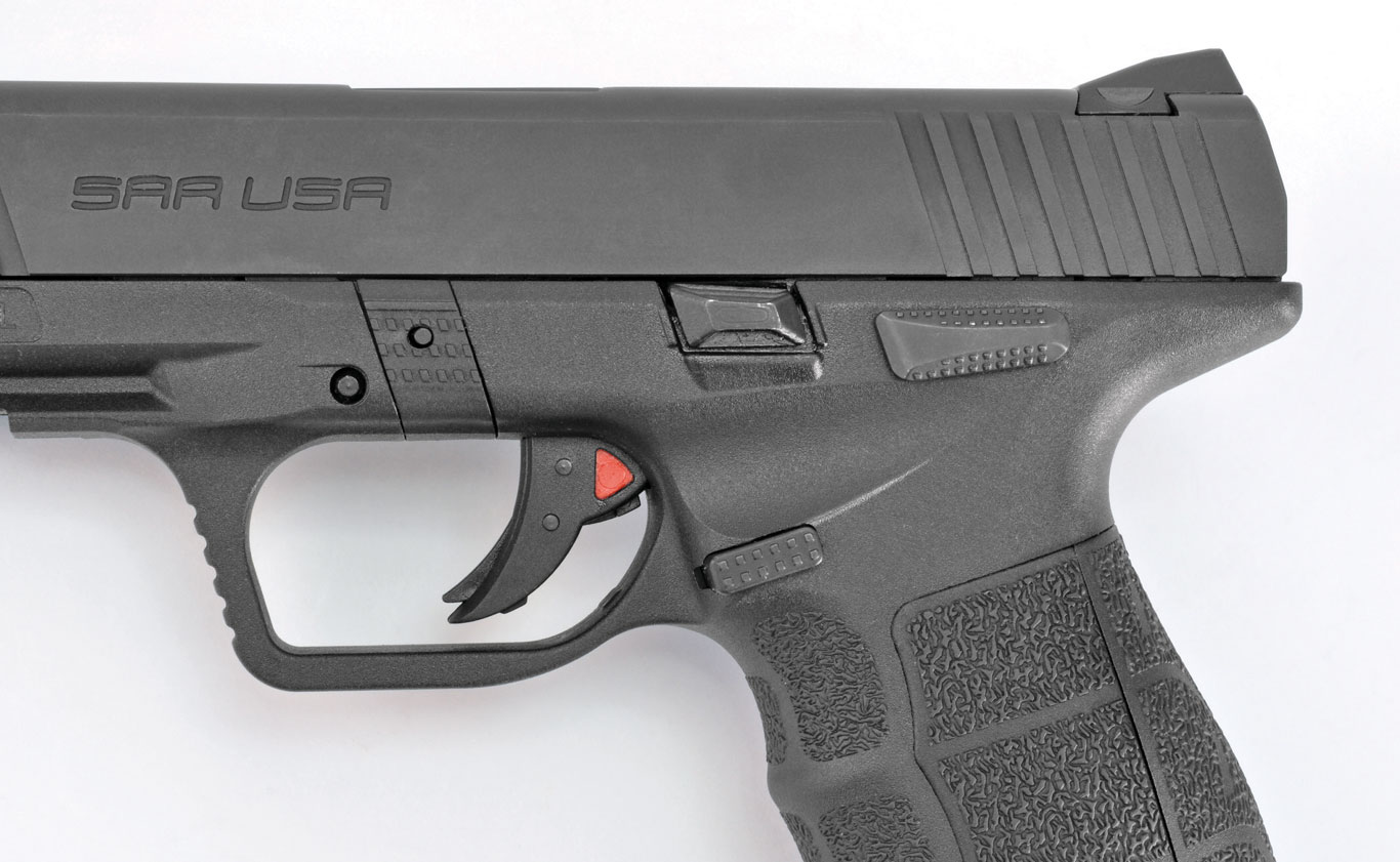 The SAR 9 features standard controls. What stands out are the triangular red cocking indicator and the significant undercut behind the trigger guard, which helps keep bore axis low.